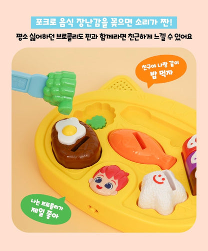  展示如何使用藍色叉子叉起西蘭花玩具，強調會發出聲音的互動功能。